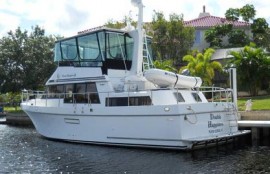 Motor yacht moored at dock in backyard.